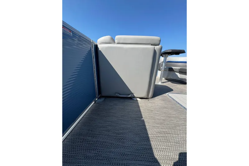 Slide: The Image of 2022 Bennington SX 23 Quad Bench interior with gray seating and blue paneling. - 11