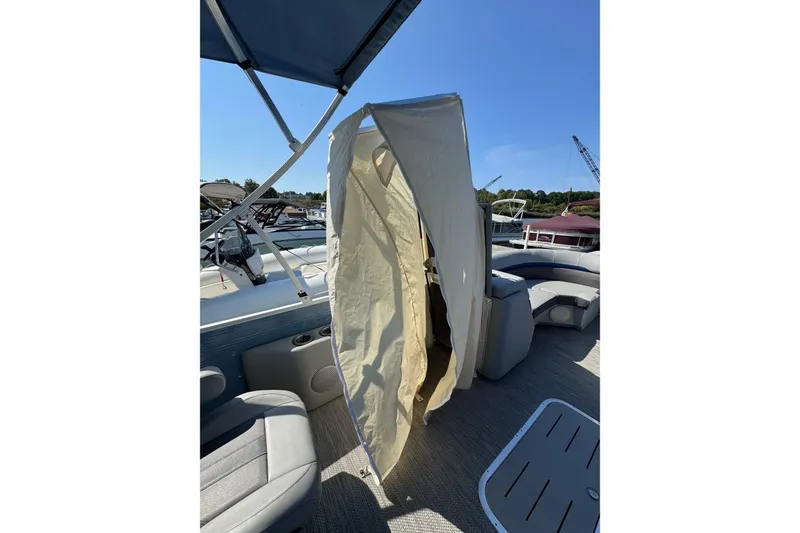 Slide: The Image of 2022 Bennington SX 23 Quad Bench boat with canopy and seating area. - 12