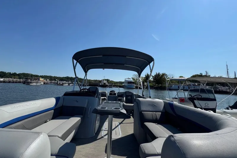 Slide: The Image of 2022 Bennington SX 23 Quad Bench pontoon boat on a sunny day at the marina. - 6