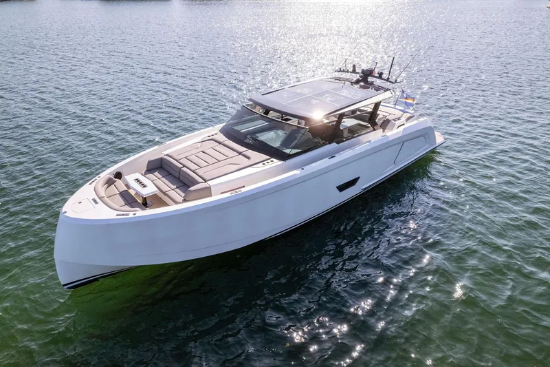 Slide: The Image of Vanquish Yachts VQ58 2022 model cruising on calm waters, showcasing sleek design. - 13