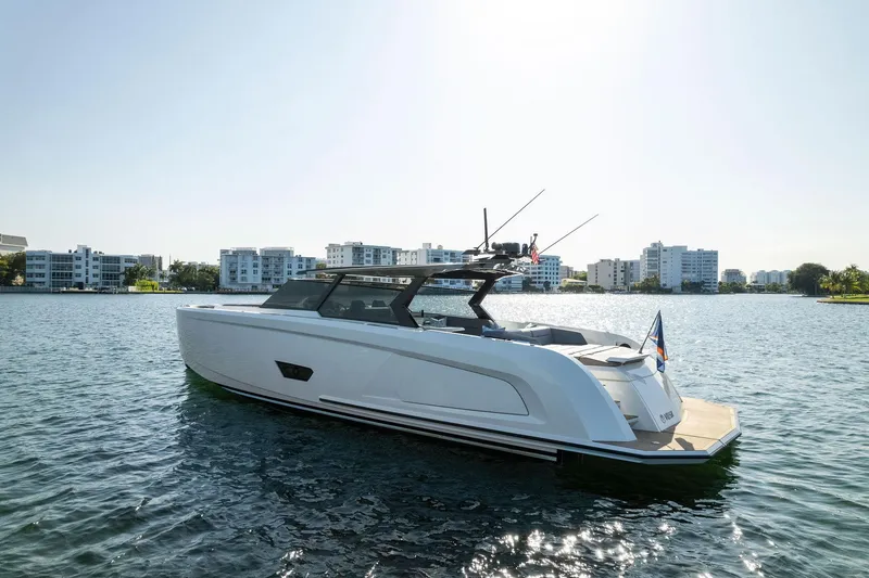 Slide: The Image of 2022 Vanquish Yachts VQ58 on water, modern design, cityscape background. - 15