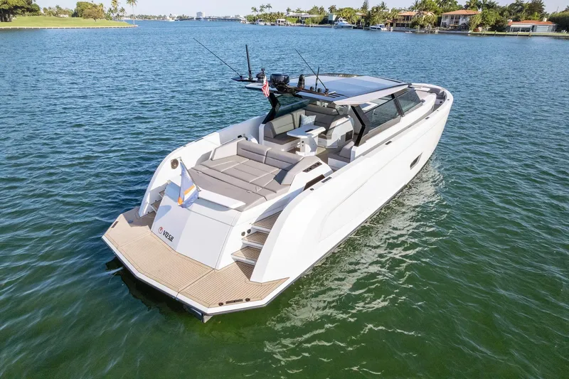 Slide: The Image of Vanquish Yachts VQ58 2022 model cruising on serene waters, showcasing luxury design. - 19