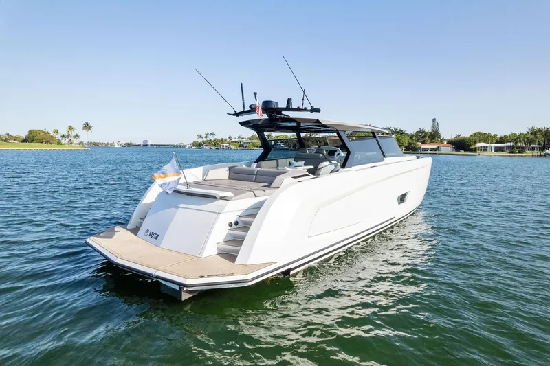 Slide: The Image of Vanquish Yachts VQ58 2022 model cruising on a serene lake. - 21