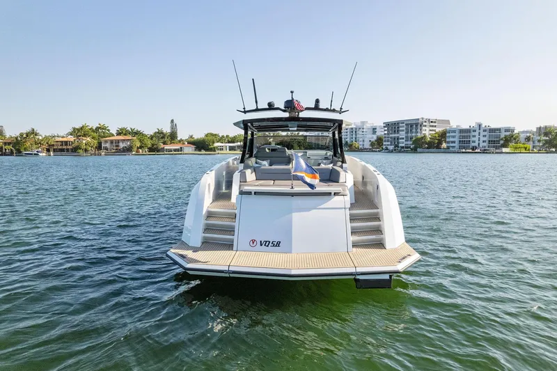 Slide: The Image of 2022 Vanquish Yachts VQ58 on water, rear view, modern design, sunny day. - 22