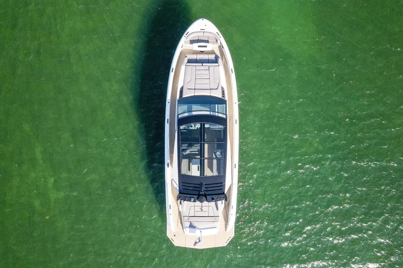 Slide: The Image of Aerial view of 2022 Vanquish Yachts VQ58 on green water. - 23