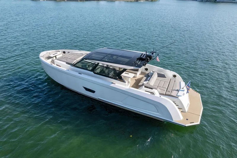 Slide: The Image of Vanquish Yachts VQ58 2022 model, sleek design, cruising on calm waters. - 25