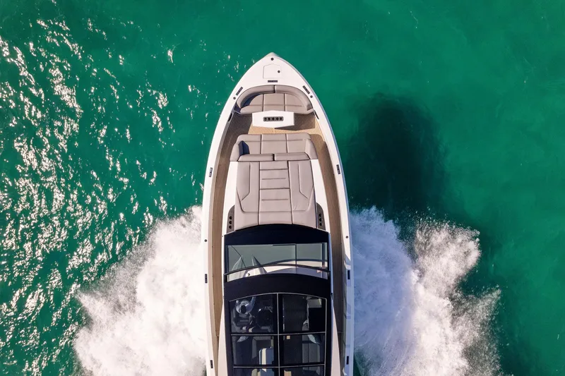 Slide: The Image of Vanquish Yachts VQ58 2022 cruising on turquoise water, aerial view. - 27