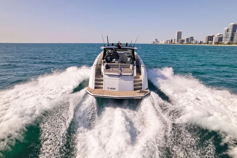 Slide: The Image of Vanquish Yachts VQ58 2022 cruising on ocean near city skyline. - 28