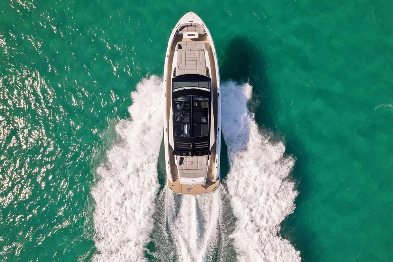 Slide: The Image of Aerial view of 2022 Vanquish Yachts VQ58 cruising on turquoise water. - 29