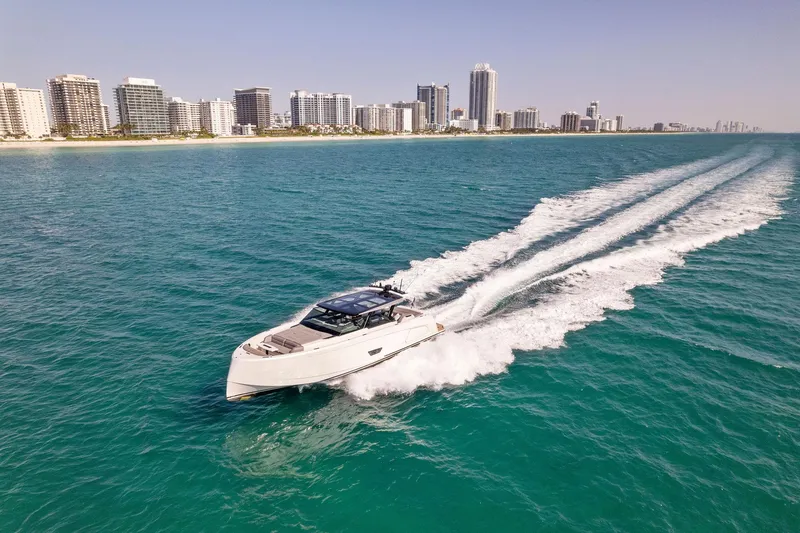 Slide: The Image of Vanquish Yachts VQ58 2022 cruising on ocean near city skyline. - 30