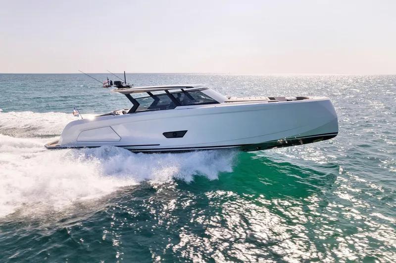 Slide: The Image of 2022 Vanquish Yachts VQ58 cruising on open water, showcasing sleek design and performance. - 32
