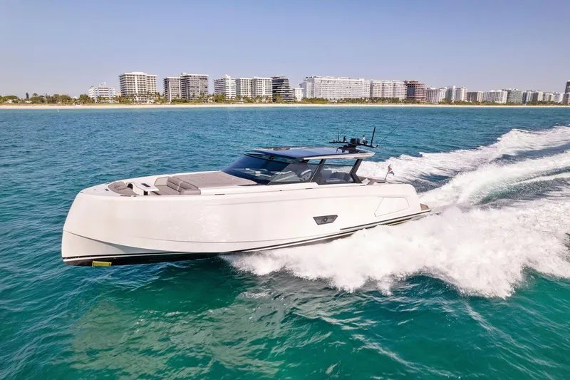 Slide: The Image of 2022 Vanquish Yachts VQ58 cruising on blue ocean near city skyline. - 33