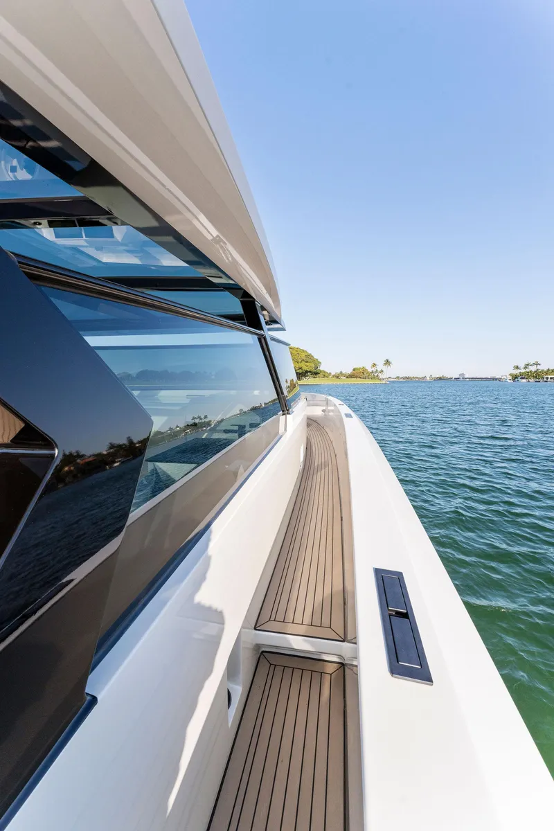Slide: The Image of 2022 Vanquish Yachts VQ58, sleek design, cruising on open water under clear blue sky. - 48