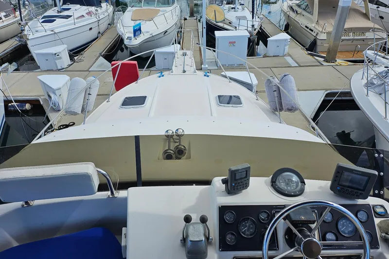Slide: The Image of 1988 Silverton 37 Motor Yacht at marina, view from helm with navigational instruments. - 11