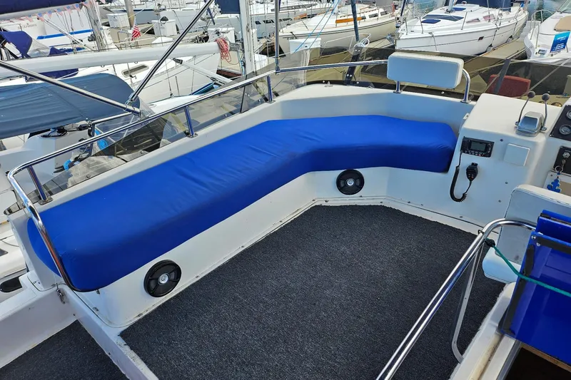 Slide: The Image of 1988 Silverton 37 Motor Yacht cockpit with blue seating, marine speakers, and control panel. - 13