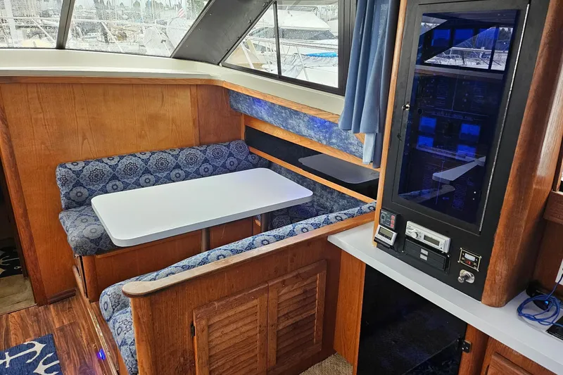 Slide: The Image of 1988 Silverton 37 Motor Yacht interior with dining area and control panel. - 17