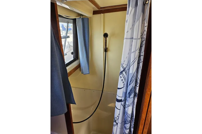 Slide: The Image of Shower area inside 1988 Silverton 37 Motor Yacht with window and curtain. - 30