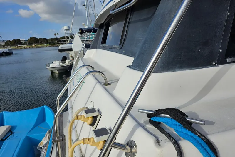 Slide: The Image of 1988 Silverton 37 Motor Yacht docked, featuring railing and electrical connections. - 6