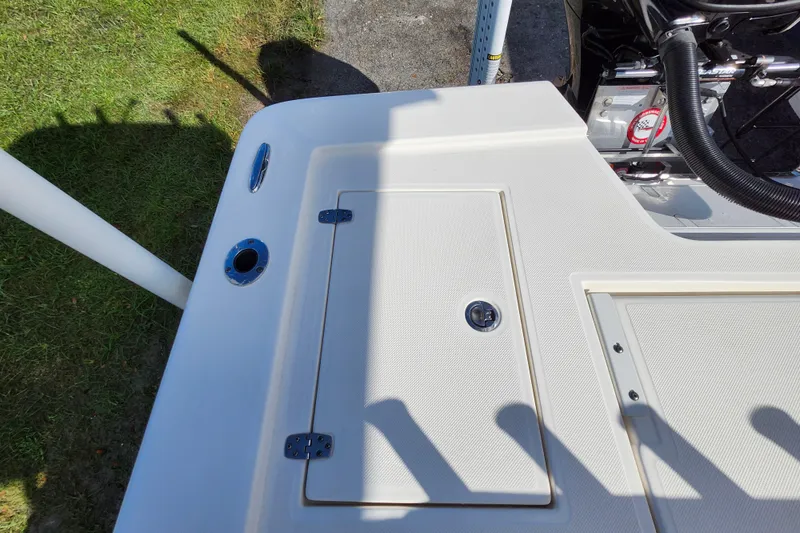 Slide: The Image of 2023 Sea Born FX22 Bay boat deck with storage compartment and engine details. - 10