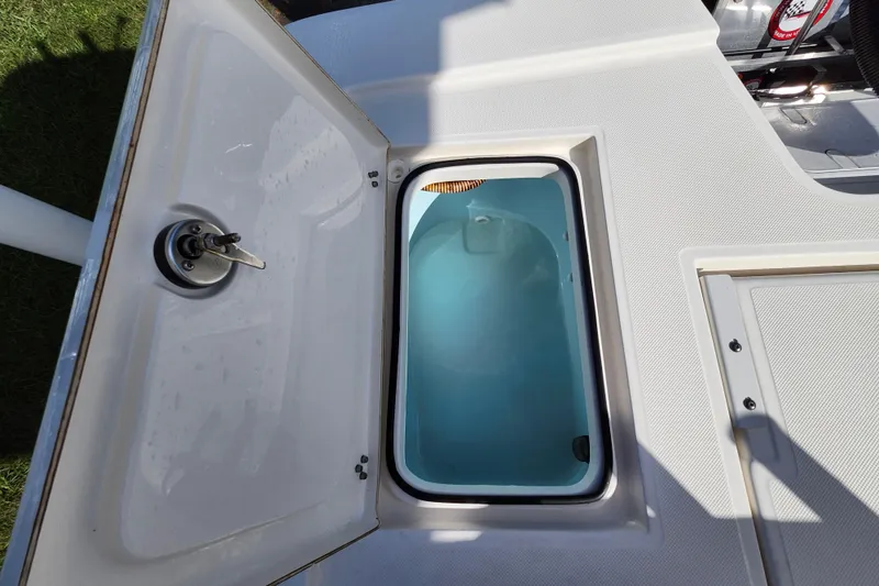 Slide: The Image of 2023 Sea Born FX22 Bay boat livewell with open lid, showcasing interior water storage. - 11