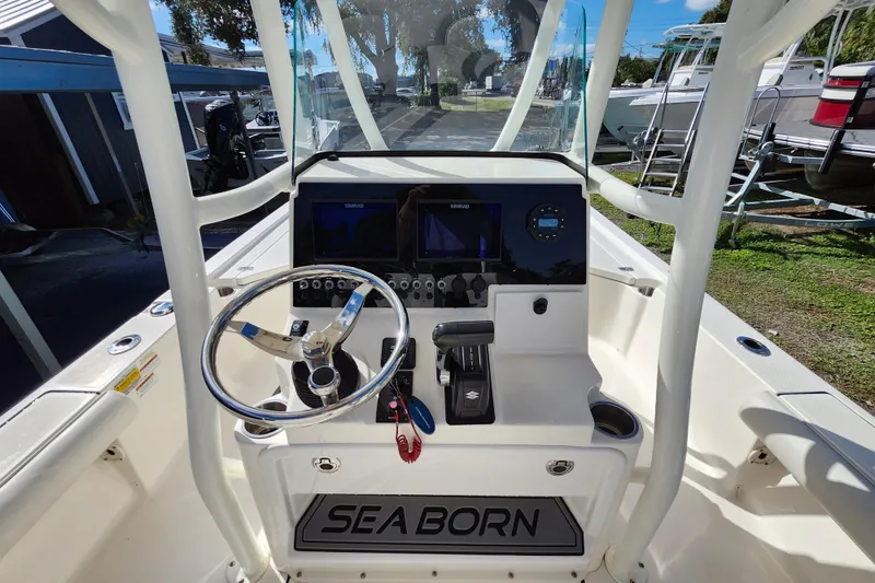 Slide: The Image of 2023 Sea Born FX22 Bay boat dashboard with steering wheel and controls. - 12