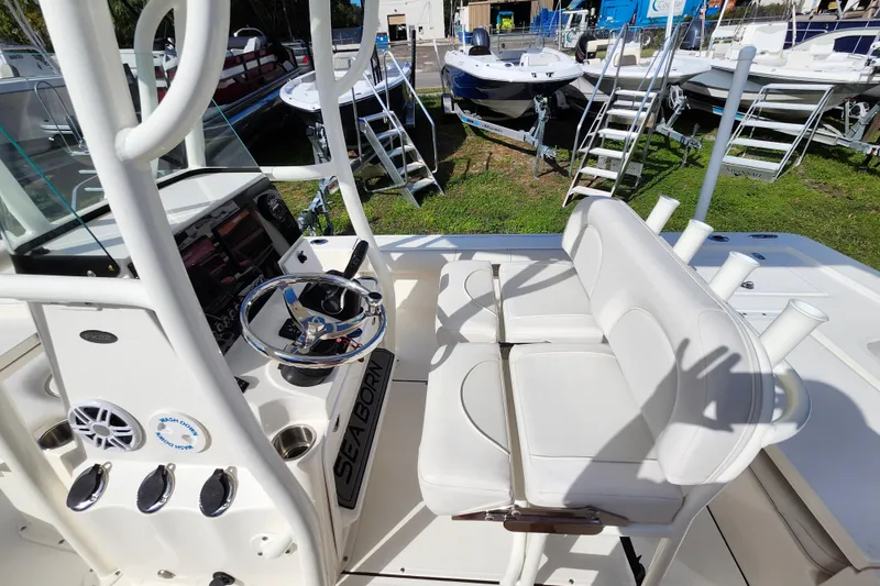 Slide: The Image of 2023 Sea Born FX22 Bay boat interior with steering wheel and seating area. - 15