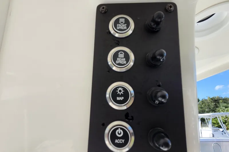 Slide: The Image of Control panel on 2023 Sea Born FX22 Bay boat with labeled buttons and switches. - 18