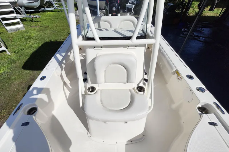 Slide: The Image of 2023 Sea Born FX22 Bay boat interior with white seating and cup holders. - 23