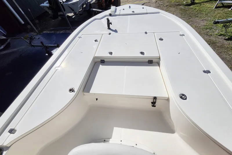 Slide: The Image of 2023 Sea Born FX22 Bay boat deck with storage compartments and clean white finish. - 25