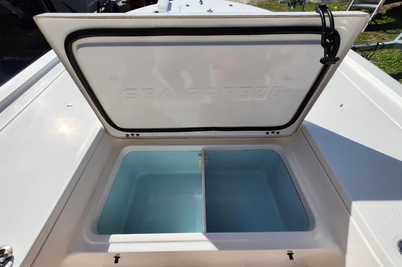 Slide: The Image of 2023 Sea Born FX22 Bay boat with open Sea Freeze storage compartment. - 28