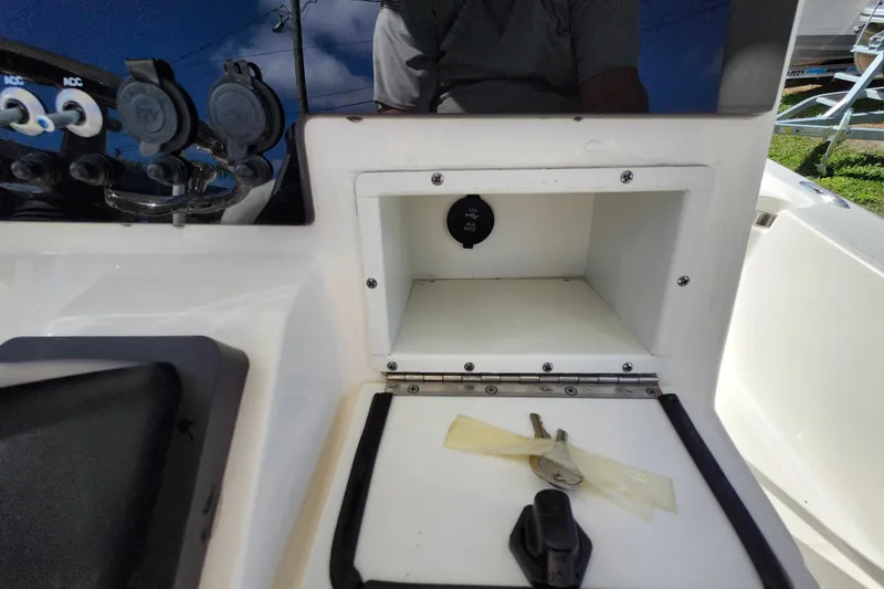 Slide: The Image of 2023 Sea Born FX22 Bay boat console with storage compartment and keys. - 34