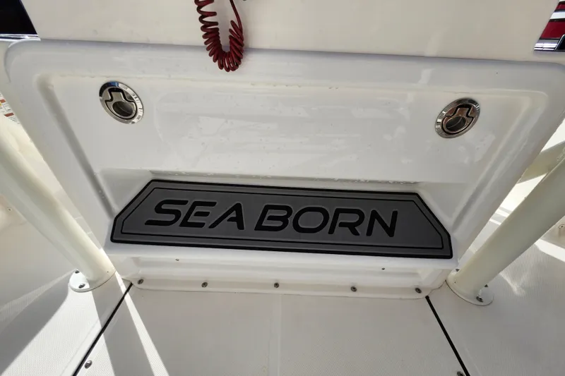 Slide: The Image of 2023 Sea Born FX22 Bay boat interior with logo and storage compartment. - 35