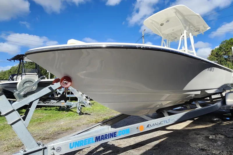 Slide: The Image of 2023 Sea Born FX22 Bay boat on trailer under blue sky. - 39