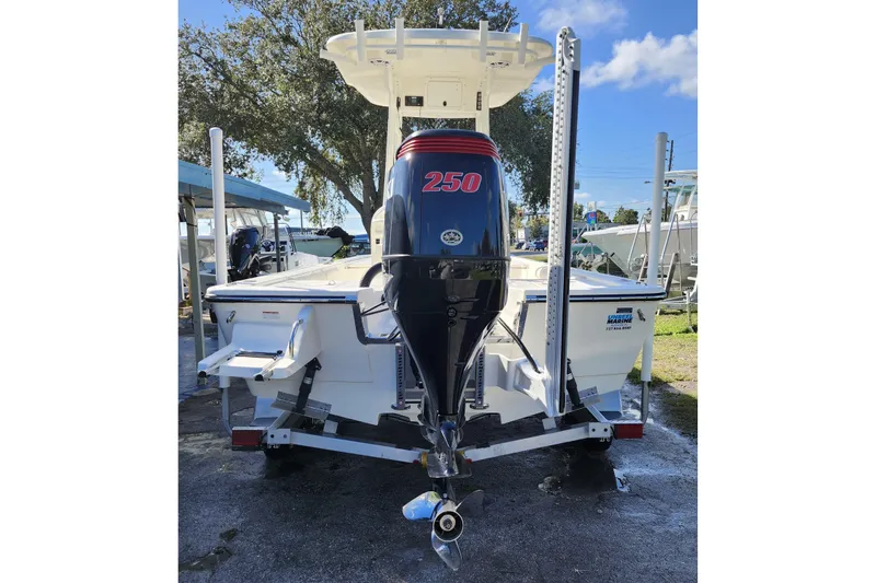 Slide: The Image of 2023 Sea Born FX22 Bay boat with powerful 250 horsepower engine, parked outdoors. - 4