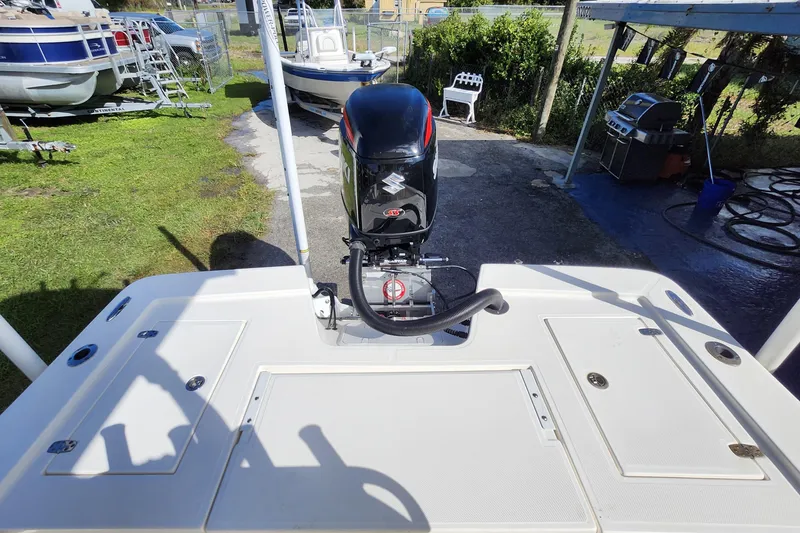 Slide: The Image of 2023 Sea Born FX22 Bay boat with outboard motor, parked outdoors. - 6
