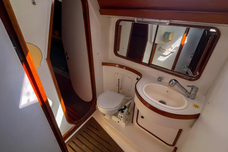 Slide: The Image of Bathroom interior of 1991 Oyster LW48 yacht with sink, toilet, and mirror. - 13