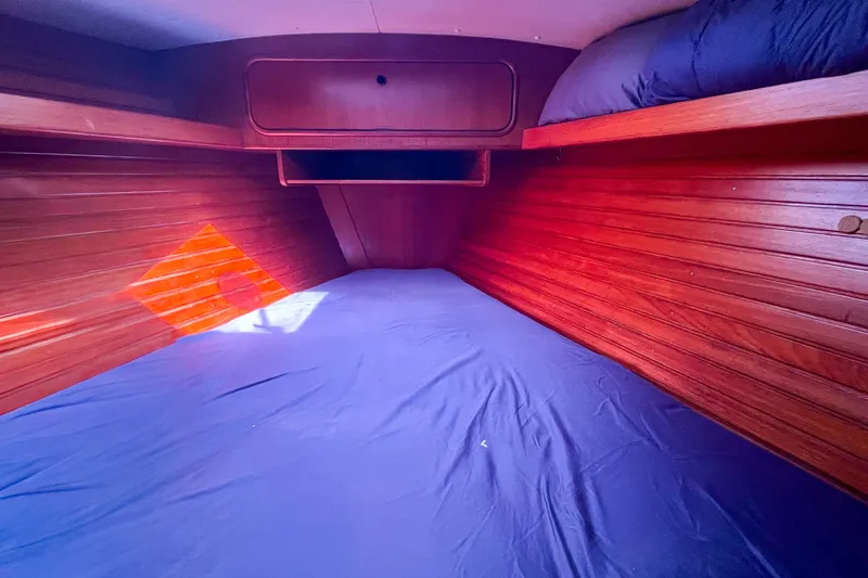 Slide: The Image of Cozy wooden cabin interior of 1991 Oyster LW48 yacht with blue bedding. - 15