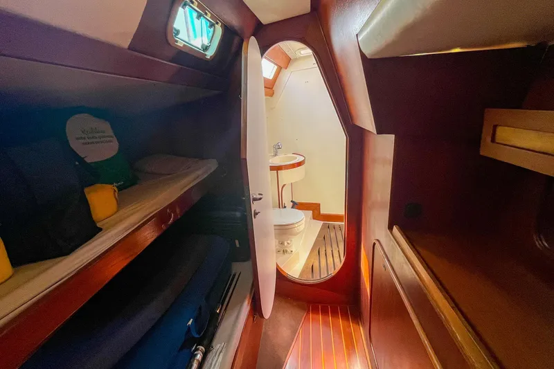 Slide: The Image of Interior of 1991 Oyster LW48 yacht with cozy cabin and compact bathroom. - 18