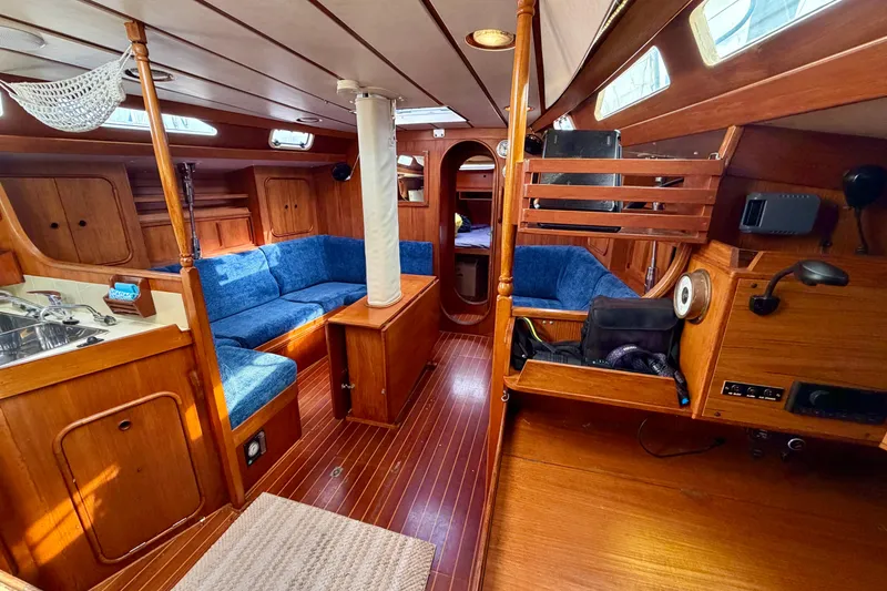 Slide: The Image of Interior of 1991 Oyster Lightwave 48 yacht with wooden finish and blue seating. - 3