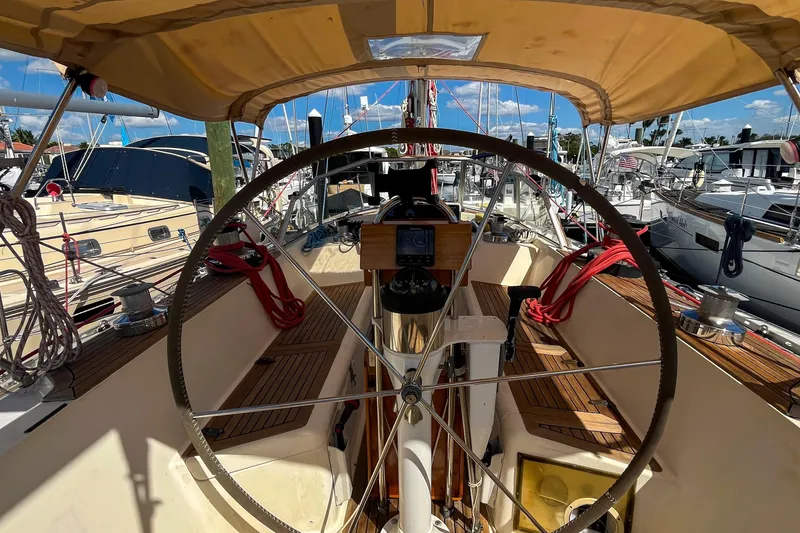 Slide: The Image of Cockpit of 1991 Oyster LW48 sailboat with wooden deck and steering wheel. - 32