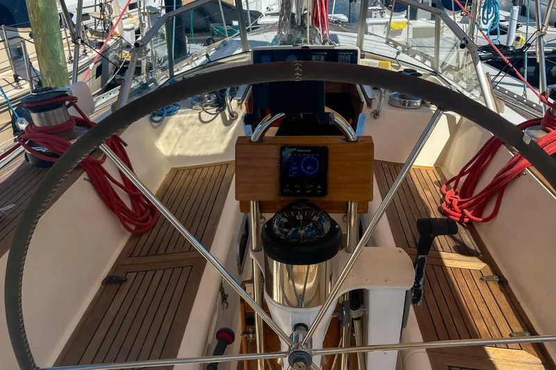 Slide: The Image of Cockpit of 1991 Oyster LW48 sailboat with steering wheel and navigation instruments. - 33