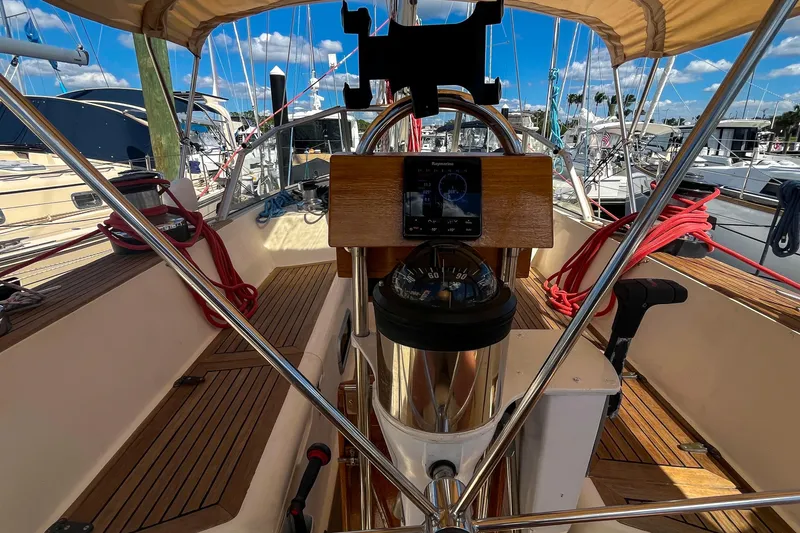 Slide: The Image of Cockpit of 1991 Oyster LW48 sailboat with navigation equipment and wooden deck. - 34