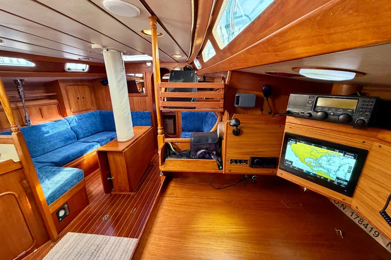 Slide: The Image of Interior of 1991 Oyster Lightwave 48 yacht with blue seating and navigation equipment. - 4