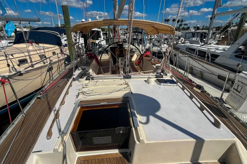 Slide: The Image of 1991 Oyster LW48 sailboat docked at marina under clear blue sky. - 45