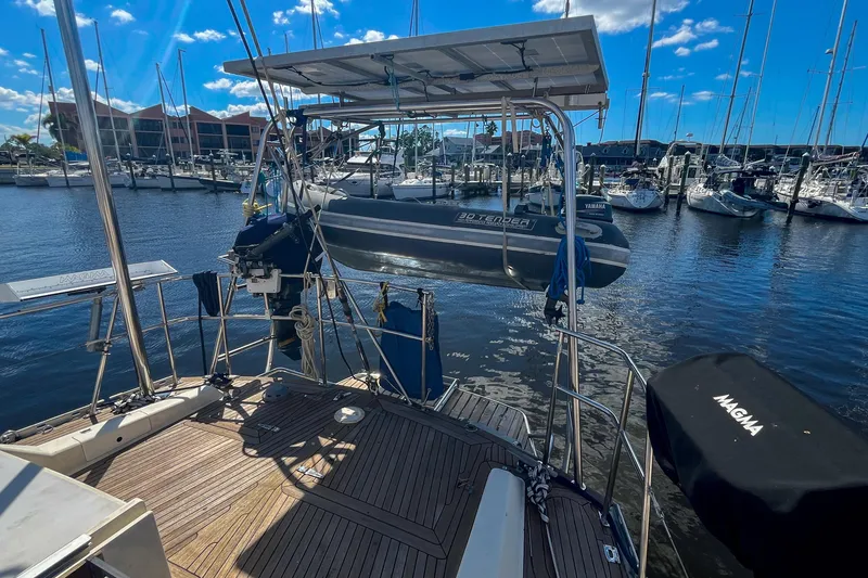Slide: The Image of Sailboat deck view with dinghy, marina background, Oyster LW48, 1991 model. - 47