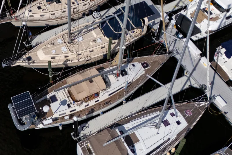 Slide: The Image of Overhead view of docked 1991 Oyster LW48 sailboats in a marina. - 51