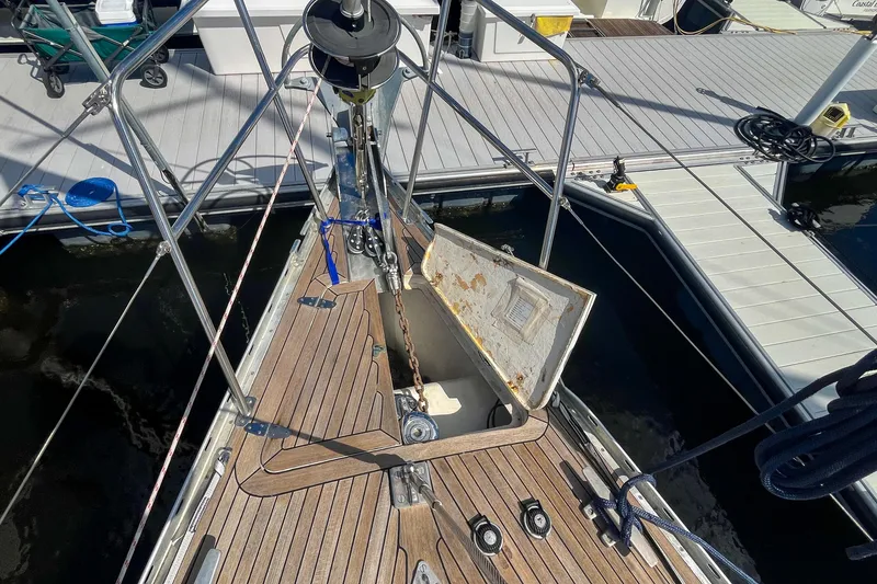 Slide: The Image of Bow of 1991 Oyster LW48 yacht with open anchor locker at marina. - 54