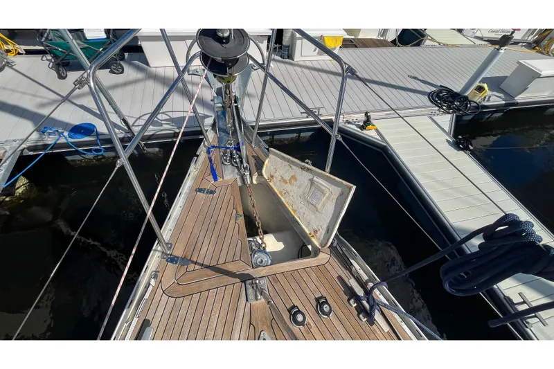 Slide: The Image of Bow of 1991 Oyster LW48 yacht with open anchor locker at marina. - 60