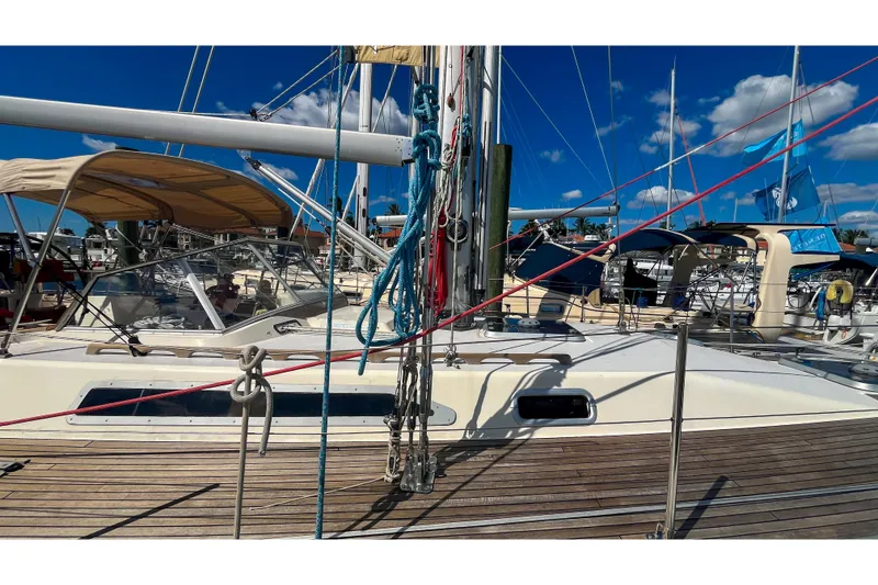 Slide: The Image of Sailboat Oyster LW48, 1991 model, docked with clear blue sky and marina background. - 64