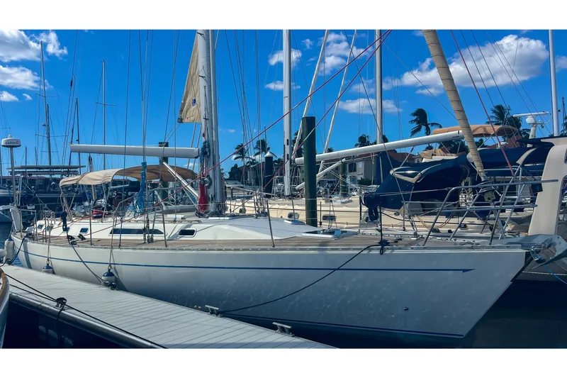 Slide: The Image of Sailboat Oyster LW48, 1991 model, docked at marina under clear blue sky. - 69